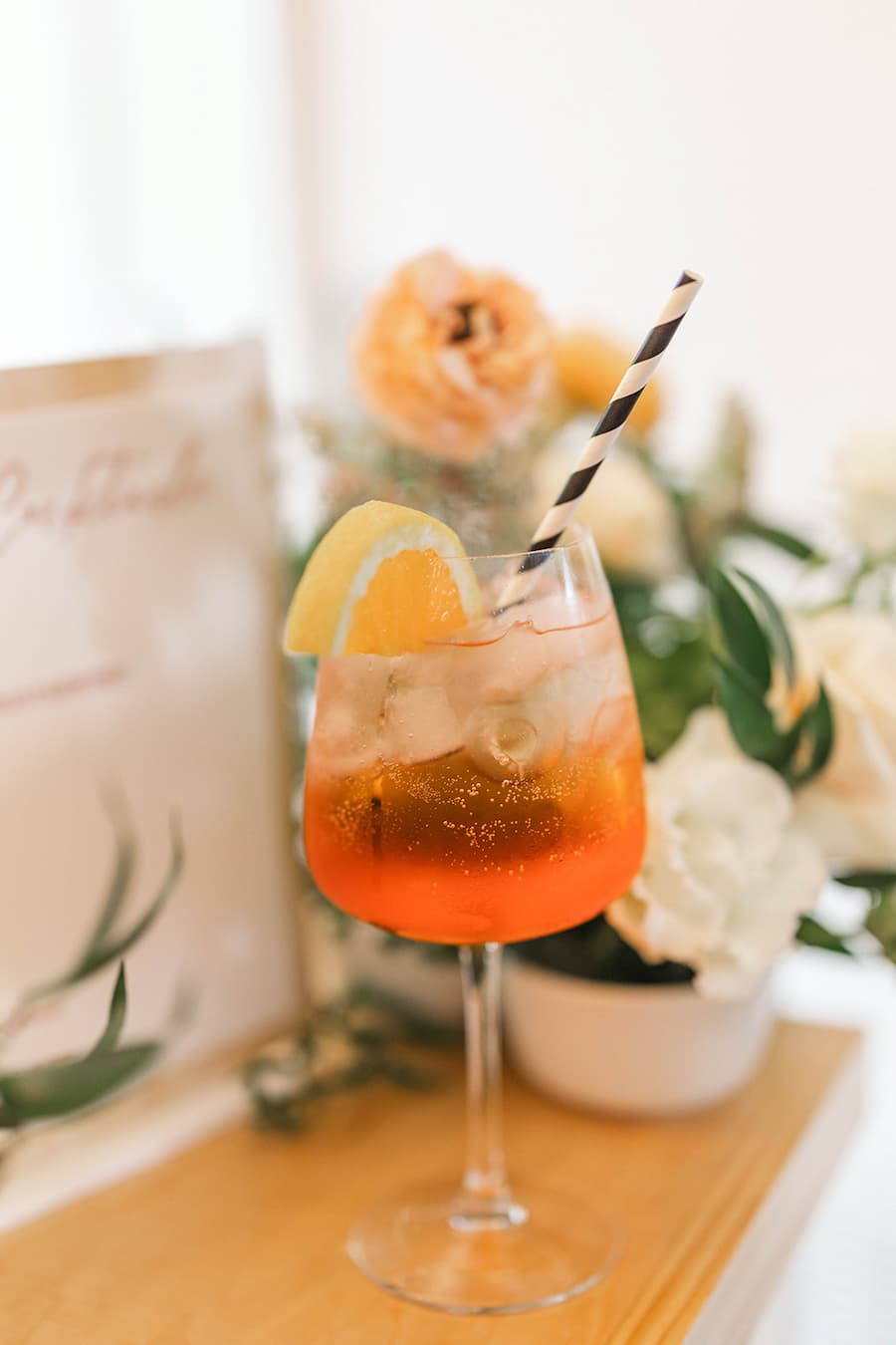Bride and groom toasting with signature cocktails at wedding reception