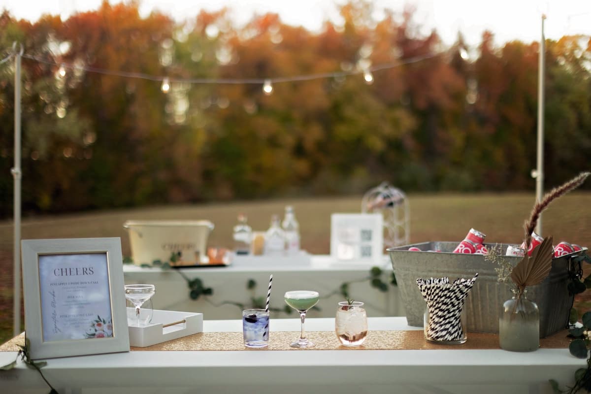 Wedding bar with signature cocktails and fall foliage by Chesapeake Bartenders and Events