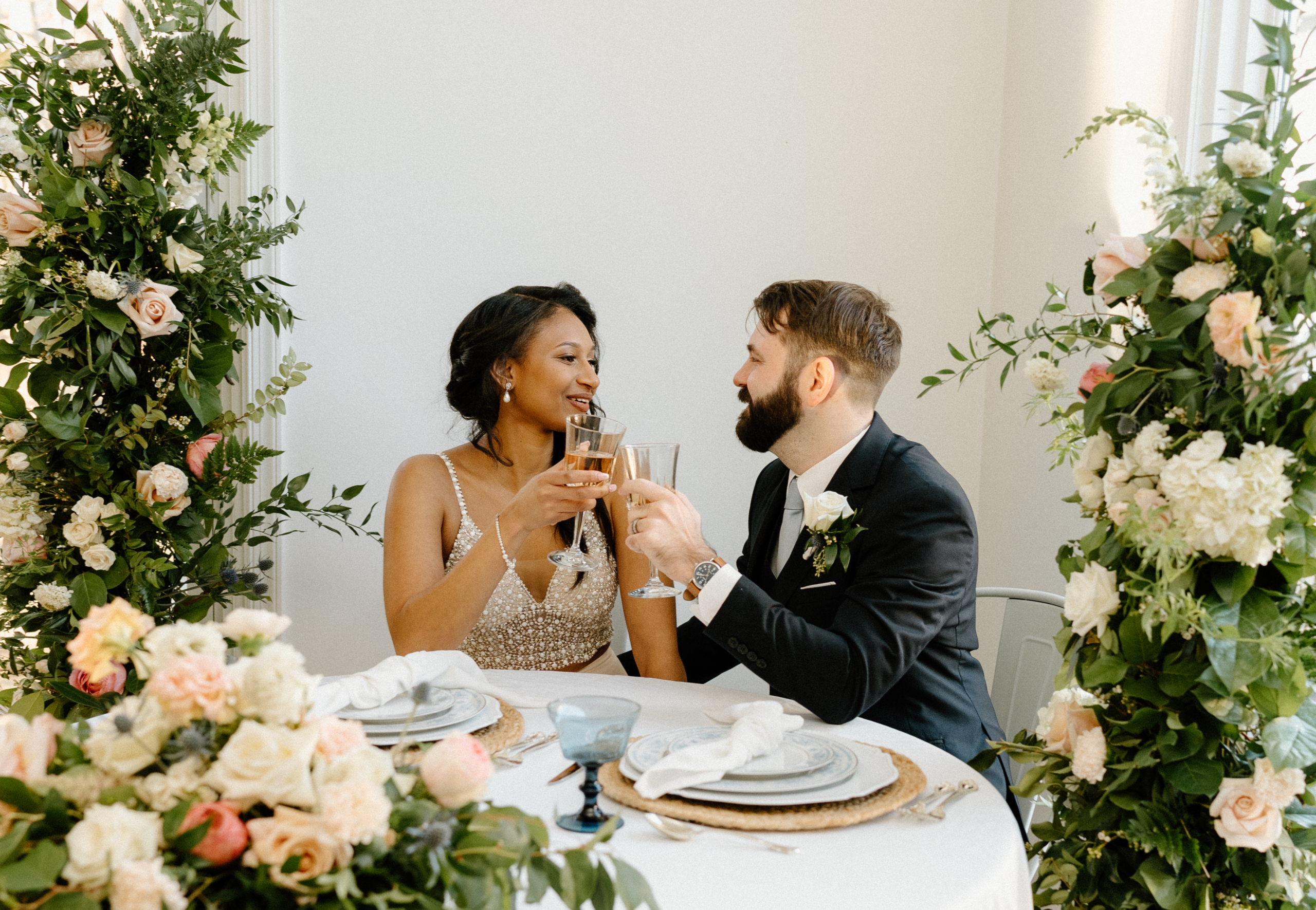 Bride and groom toasting with signature cocktails at their sweetheart table during a styled wedding shoot at 1631 Event Venue on Kent Island Maryland