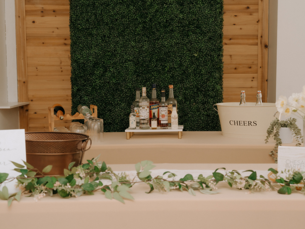 CHEERS enamel wine tin filled with ice and wine bottles at a wedding bar
