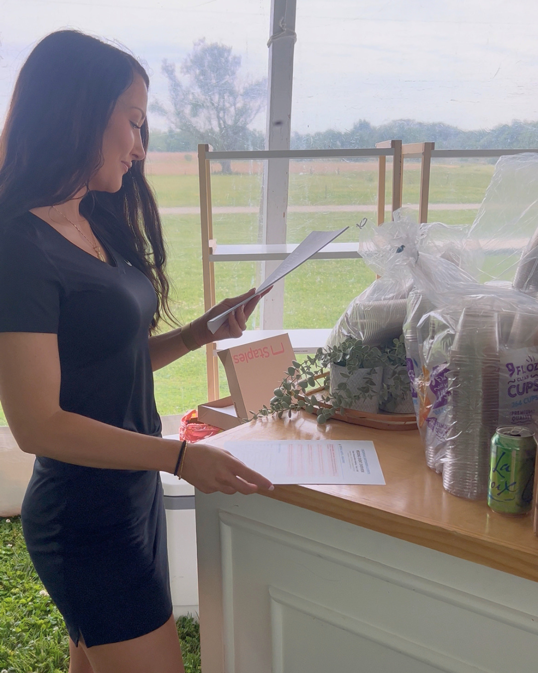 CBE team reviewing 12-page wedding bar overview during setup at Stepne Manor